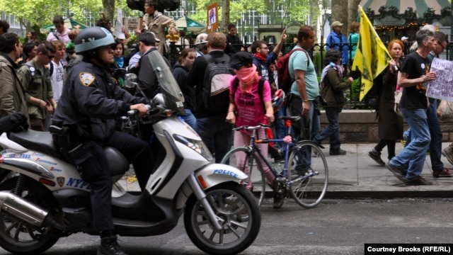Still going strong? A police officer rides alongside an Occupy demonstration in New York in May.
