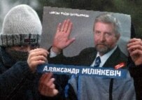 A masked supporter of Belarus opposition leader and presidential candidate Alyaksandr Milinkevich holds his poster during a preelection meeting in Borisov, Belarus today (epa)