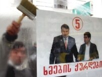An opposition poster hung before a February 8 demonstration accuses the president of being a \