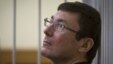 Former Interior Minister Yuriy Lutsenko looks on from the defendant