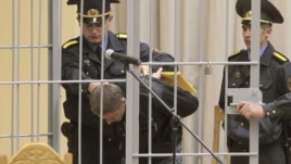 Uladzislau Kavalyou is led into a holding cage before hearings in Minsk on September 15.