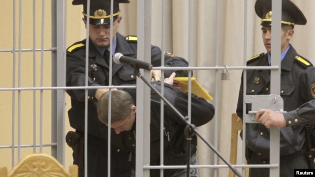 Uladzislau Kavalyou is led into a holding cage before hearings in Minsk on September 15.