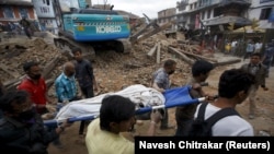 Rescue workers remove the body of a victim in Kathmandu.