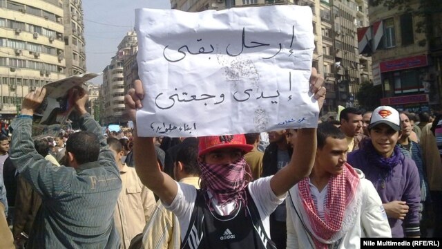 A young protester during the antigovernment demonstrations in Cairo's Tahrir Square in February 2011: "Enough already, my arms hurt!"