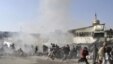 People react seconds after a suicide blast targeting a Shi