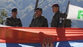Kosovo Force (KFOR) Major General Erhard Drews  of Germany stands along the barricades in front of a Serbian flag at the closed Serbia-Kosovo border crossing of Brnjak, on October 19.  