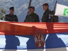 Kosovo Force (KFOR) Major General Erhard Drews of Germany stands along the barricades in front of a Serbian flag at the closed Serbia-Kosovo border crossing of Brnjak, on October 19. 