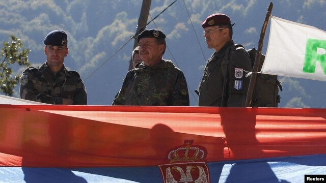 Kosovo Force (KFOR) Major General Erhard Drews  of Germany stands along the barricades in front of a Serbian flag at the closed Serbia-Kosovo border crossing of Brnjak, on October 19.  
