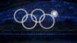Participants march by as one of the Olympic rings fails to completely illuminate during the opening ceremony of the 2014 Sochi Winter Olympics on February 7.