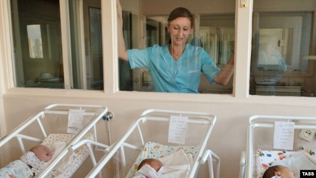 Precious youth: A nurse watches over newborns at a Moscow maternity hospital. (file photo)