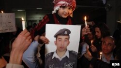 By a chilling coincidence, the young medical student-turned-suicide bomber hailed from Al-Karak, a province southwest of the Jordanian capital, Amman, that was also the home of Jordanian pilot Muath al-Kasasbeh (pictured,in photograph), who was burned alive by IS militants in February.