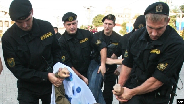 Riot police detain an opposition supporter in Minsk during a protest against Belarus and Russia military exercises in September 2009.