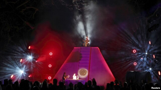A Mayan priest sits atop a pyramid as Richard Garriott addresses guests at his "End of the World Soiree" dress rehearsal in Austin, Texas. 