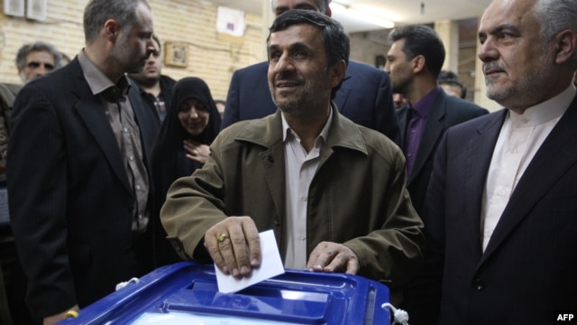 Iran's new election law is seen by some as the outcome of a power struggle between President Mahmud Ahmadinejad (center) and Supreme Leader Ayatollah Ali Khamenei.