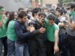 Protesters try to help a riot policeman who was beaten during the street clashes.
