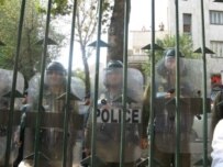 Police guard a gate at Tehran University in the face of protests on October 8