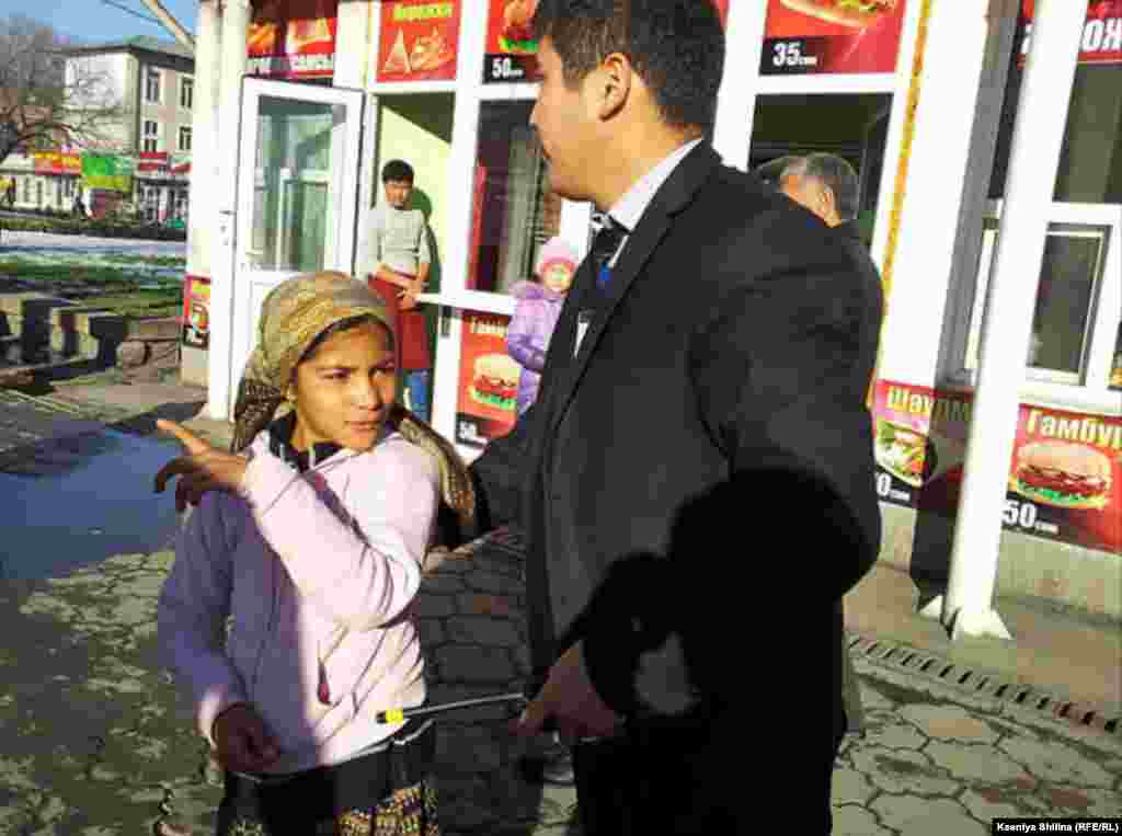 A security guard escorts a girl away from a restaurant.