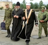Regimental clerics Father Vladimir of the Russian Orthodox Church and Muslim Imam Muharab visiting a Cossack regiment in 2001 (ITAR-TASS)
