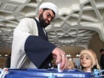An Iranian cleric casts his ballot at a polling station in the Shi'ite holy shrine of Massoumeh in Qom (AFP)