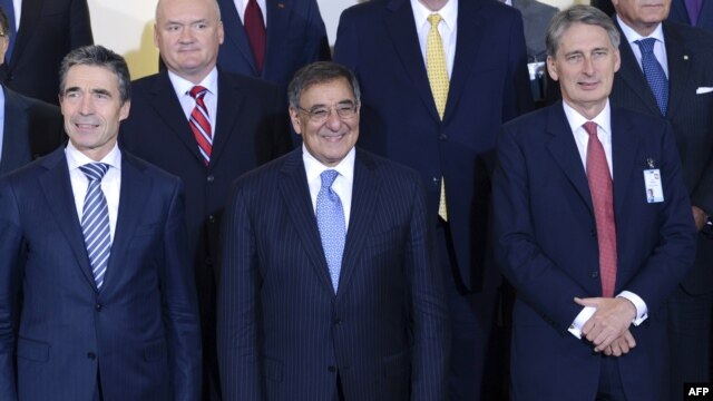 NATO Secretary General Anders Fogh Rasmussen, US Defense Secretary Leon Panetta and Britain's Secretary of Defense Philip Hammond pose for a  photo at the NATO Defense Ministers meeting at the NATO headquarter in Brussels