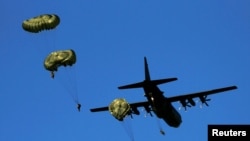 Paratroopers jump from a C-130 Hercules plane during NATO allies' Anakonda 16 exercise in June.
