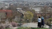 Жоолукчан аялдар Сулайман тоодон Ош шаарын карап турат. (Бул сүрөттүн макала каармандарына тиешеси жок.)