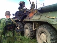 Russian soldiers remove bodies from an armored personnel carrier following an attack in July (ITAR-TASS)