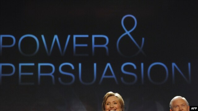 U.S. Secretary of State Hillary Clinton (left) and Defense Secretary Robert Gates take the stage at George Washington University.