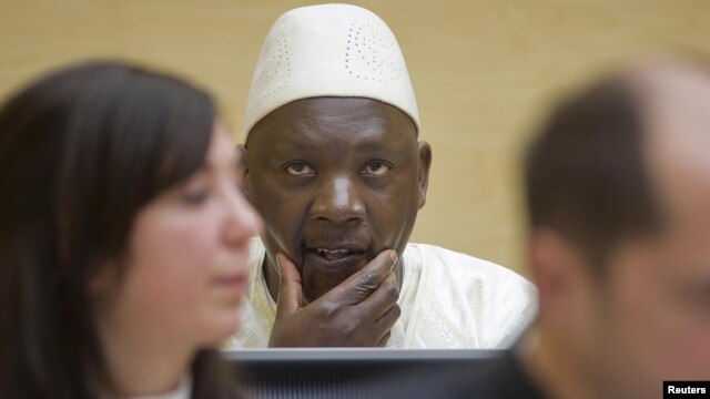 Congolese warlard Thomas Lubanga is seen behind his lawyers in the courtroom of the International Criminal Court (ICC) at The Hague.