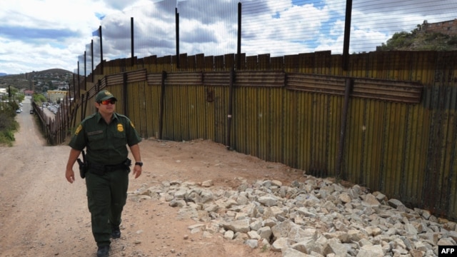A U.S. security officer patrols along a border fence with neighboring Mexico designed to keep out illegal immigrants.  