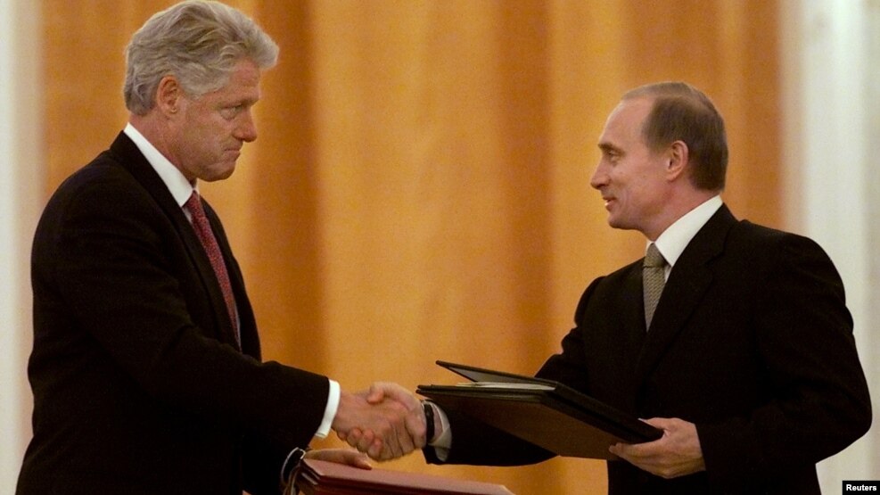 Russian President Vladimir Putin (right) and U.S. President Bill Clinton exchange agreements on the safe disposition of 68 metric tons of weapons-grade plutonium in Moscow on June 4, 2000.