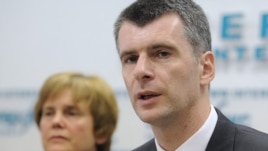 Mikhail Prokhorov (right) and his sister Irina hold a press conference in Moscow on June 4.