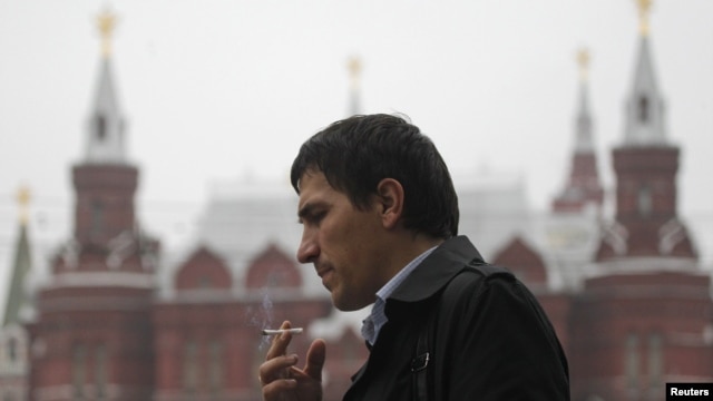 A man smokes on a street in central Moscow