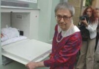 An actor portrays a mother placing her newborn in a babybox