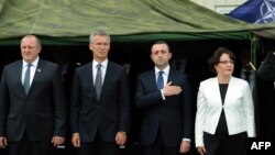 Georgian President Giorgi Margvelashvili (left to right), NATO Secretary-General Jens Stoltenberg, Georgian Prime Minister Irakli Garibashvili, and Georgian Defense Minister Tinatin Khidasheli take part in the inauguration ceremony of the NATO-Georgian Joint Training and Evaluation Center outside Tbilisi on August 27.