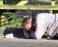 A drunk man lies passed out in a Minsk park in July (Bymedia.net)