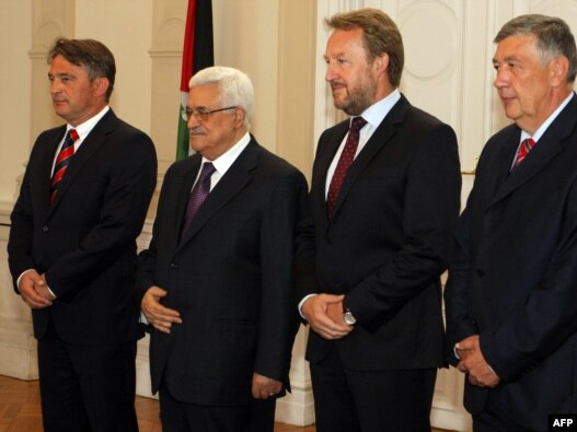 Palestinian President Mahmud Abbas (second from left) is welcomed by members of Bosnian Presidency, Zeljko Komsic (left), Bakir Izetbegovic (second from right), and Nebojsa Radmanovic (right) upon his arrival for bilateral talks in Sarajevo on August 15.