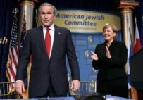 Merkel (right) applauding Bush at dinner on May 4 (epa)