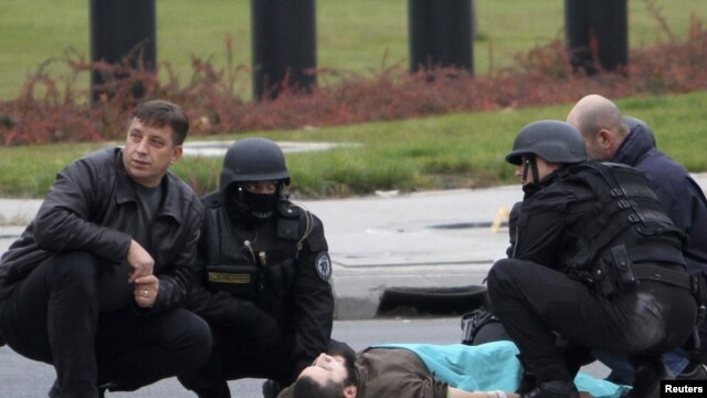A gunman identified as Mevlik Jasarevic lies on the street after being overwhelmed after he fired shots at the U.S. Embassy in Sarajevo on October 28.