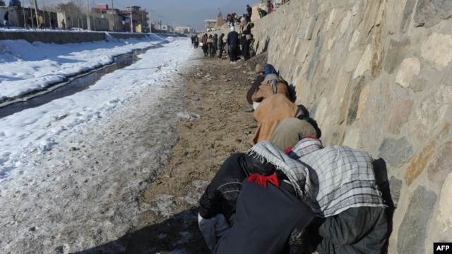 Drug addicts use heroin and other narcotics near the Kabul River in the capital.