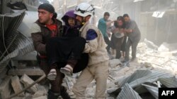 Алепподағы әуе шабуылы болған ауданда жаралы адамды әкетіп барады. Сирия, 22 сәуір 2016 жыл.