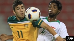 Iraqi player Jasim Faisal (right) fights for the ball with Dimitrios Petratos of Australia during their qualifying match in Doha in November.