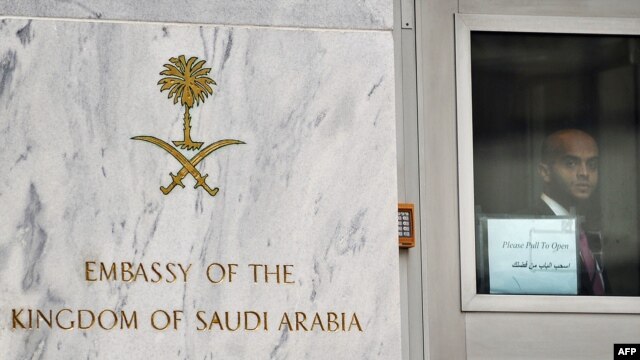 A staffer looks through the door at the entrance to the Saudi Embassy in Washington on October 11.