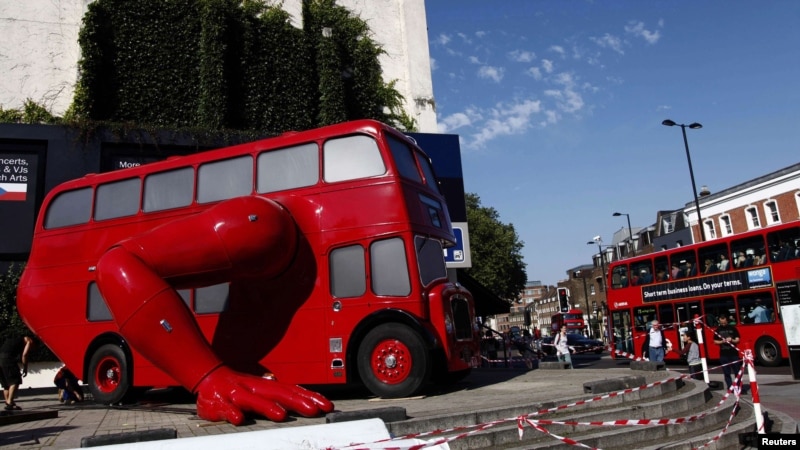 A London bus that has been transformed into a robotic sculpture by Czech artist David Cerny is assembled in front of the Czech Olympic headquarters in London. Credit: Marika Kochiashvili/REUTERS