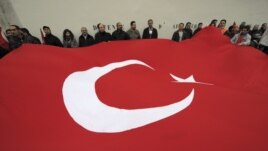 France -- Franco-Turk protesters hold a giant Turkish flag during a demonstration next to the National Assembly in Paris, 22Dec2011