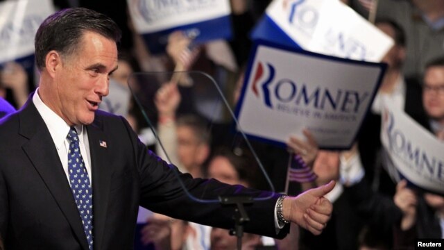 U.S. Republican presidential hopeful Mitt Romney greets supporters at his primary night rally in Manchester, New Hampshire. 