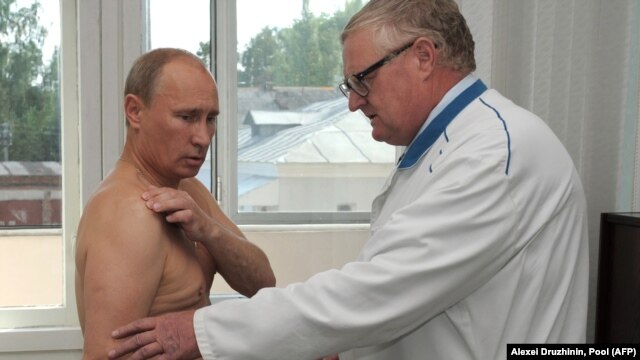 Russian President Vladimir Putin (left) reportedly strained his back while exercising. (file photo)