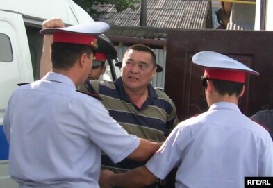 Ramazan Esergepov is escorted by police to a courthouse in Taraz in August.