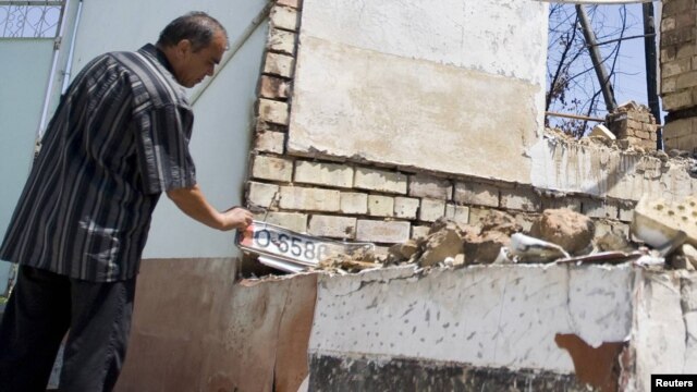 An ethnic Uzbek man in the yard of his house, burned out during the ethnic clashes in Osh in June.