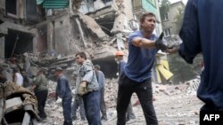 Rescue workers and local residents remove debris of an apartment building near Donetsk hit by an air strike. The war-torn Donetsk region's self-styled leaders say the situation there is now "extremely serious."